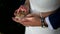 Newlyweds holding wedding rings
