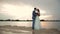 Newlyweds kissing on the river bank