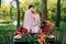 Newlyweds kissing under the plaid next to the festive table. Bride and groom in the park. Autumn wedding. Artwork