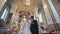 The newlyweds leave the church after their wedding in the Catholic Church.