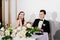 newlyweds listen to toasts, congratulations from guests and laugh