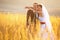 Newlyweds look hopeful posing on the field