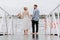 The newlyweds on the pier. The bride and groom go barefoot along the wharf