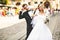 Newlyweds play tired standing on the street in a sunny day