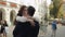 Newlyweds portrait, caucasian groom bride dancing, embracing, hugs on city street, wedding couple