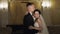Newlyweds portrait, caucasian groom bride walking, embracing, hugs in large room, wedding couple