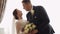 Newlyweds portrait, caucasian groom bride walking, embracing, hugs in living room, wedding couple