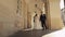 Newlyweds portrait, caucasian groom bride walking, holding hands on Lviv city street, wedding couple