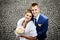 Newlyweds smiling, view from above, on a background of cobblestones.