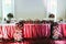 Newlyweds table covered with red cloth, decorated with roses and