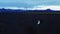 Newlyweds walking on volcanic field, panoramic view.