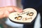 Newlyweds wedding rings on a wooden heart-shaped stand in the church