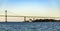 Newport Bridge with lighthouse in sunset