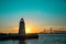 Newport Harbor Lighthouse with bridge and colorful sky