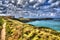 Newquay coast path to the Headland Cornwall UK in bright colourful HDR with cloudscape