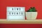 News Events word in light box on red and wooden shelves background