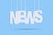 News hanging with strings on blue background with shadow white lettering journal sign media text letters