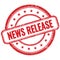 NEWS RELEASE text on red grungy round rubber stamp