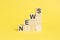 NEWS - text on wooden cubes, yellow background