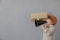 Newsboy shouting against grunge wall background. Boy selling newspaper