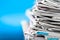 Newspapers folded and stacked on the table with blue background.Closeup newspaper and selective focus image.Time to read concept