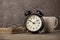 Newspapers, glasses, alarm clock and coffee cup on desktop