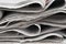 Newspapers piled up close-up background