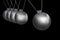 Newtons cradle silver balls on black background