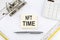 NFT TIME - business concept, message on the sticker on folder background with calculator