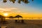 NGAPALI, MYANMAR - DECEMBER 5, 2016: Sunset on the beach, deck chairs with an umbrella. Copy space for text.