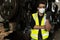 Ngineer man wearing face mask and and using walkie-talkie in factory