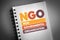 NGO - Non-Governmental Organization acronym on notepad, business concept background