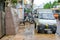 Nha Trang  Vietnam - November 2017: white van and motorbikes on street in cloudy day before typhoon Damrey