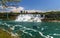 Niagara Falls, looking down the Niagara river. View of the river, observation tower, watefalls, cruise boats, city skyline.