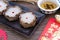 Nian Gao or sticky rice cake and Tea with Red Envelope Cash gift on wooden background  Chinese New Year`s concept