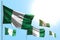 Nice 5 flags of Nigeria are wave against blue sky picture with soft focus - any celebration flag 3d illustration