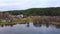 Nice aerial view of the lake and green forest with houses