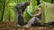 Nice aged couple preparing the tent in the forest