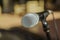 Nice amazing view of microphone detailed head against blurred outdoor background