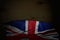 Nice any feast flag 3d illustration - dark illustration of United Kingdom UK flag with large folds on dark wood with free place