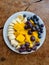 nice arranged fruits on a plate, , blueberries, mango, ananas, grapes, bananas