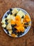 nice arranged fruits on a plate, papaya, blueberries, ananas, orange, mango, kiwi