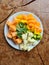 nice arranged fruits on a plate, papaya, grapefruit, ananas, orange, mango, kiwi