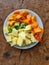 nice arranged fruits on a plate, persimmon, ananas, kiwi