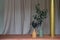 Nice artificial plant in ceramic vases setting on empty brick bench with gold column in minimal modern style apartment /