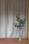 Nice artificial plant in ceramic vases setting on empty brick bench with gold column in minimal modern style apartment /