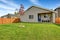 Nice back yard with well kept lawn and view of covered porch with fireplace