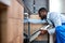 Nice Black Handyman in Blue Overalls Uniform Is Going To Repair Dishwasher