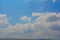 Nice blue sky on a sunny day with a wall of clouds and a mountain on the bottom