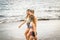 Nice bodies young women models walking together in friendship on the shore near the ocean for summer vacation leisure. outdoor